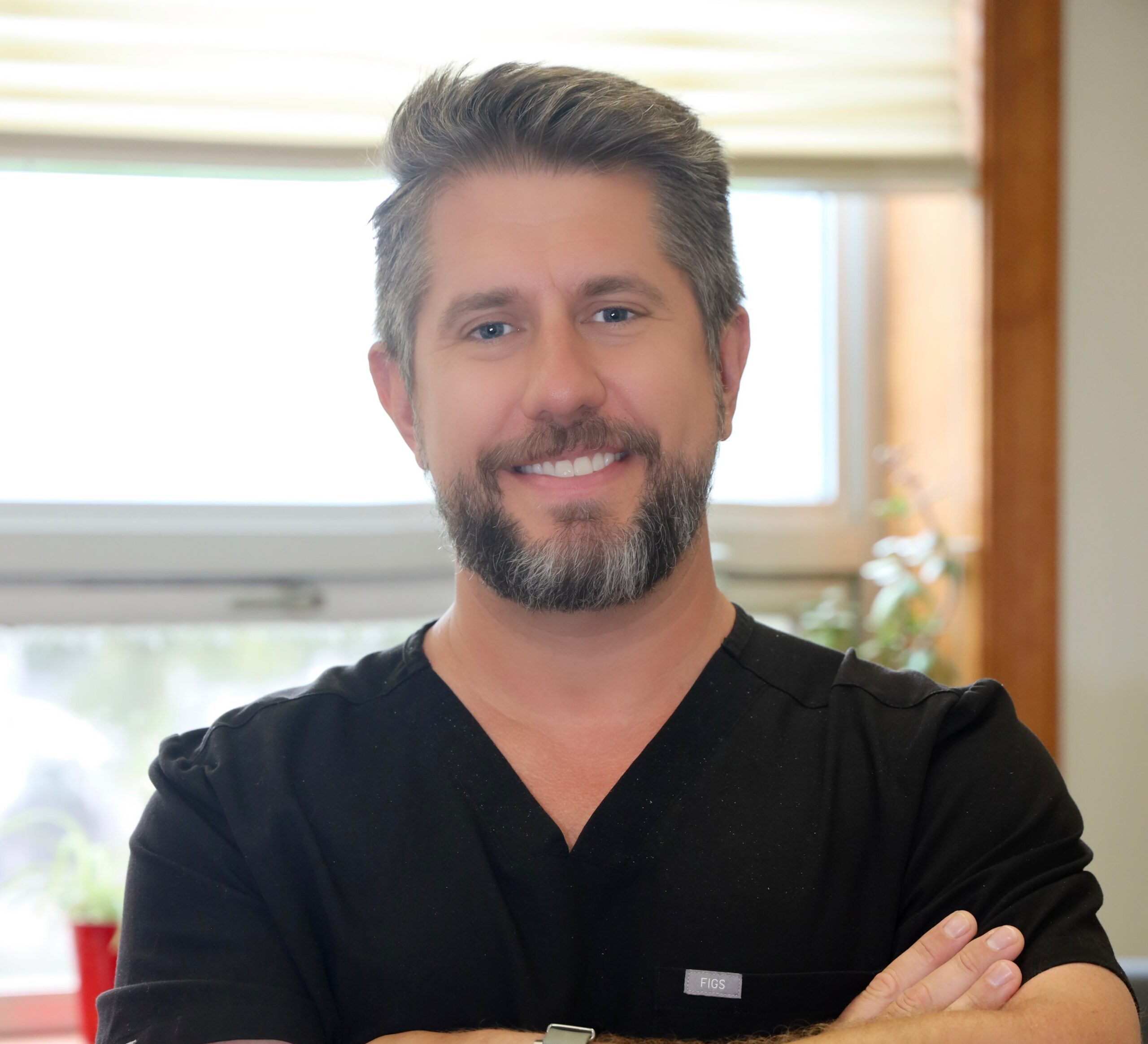 A man with beard and mustache wearing black shirt